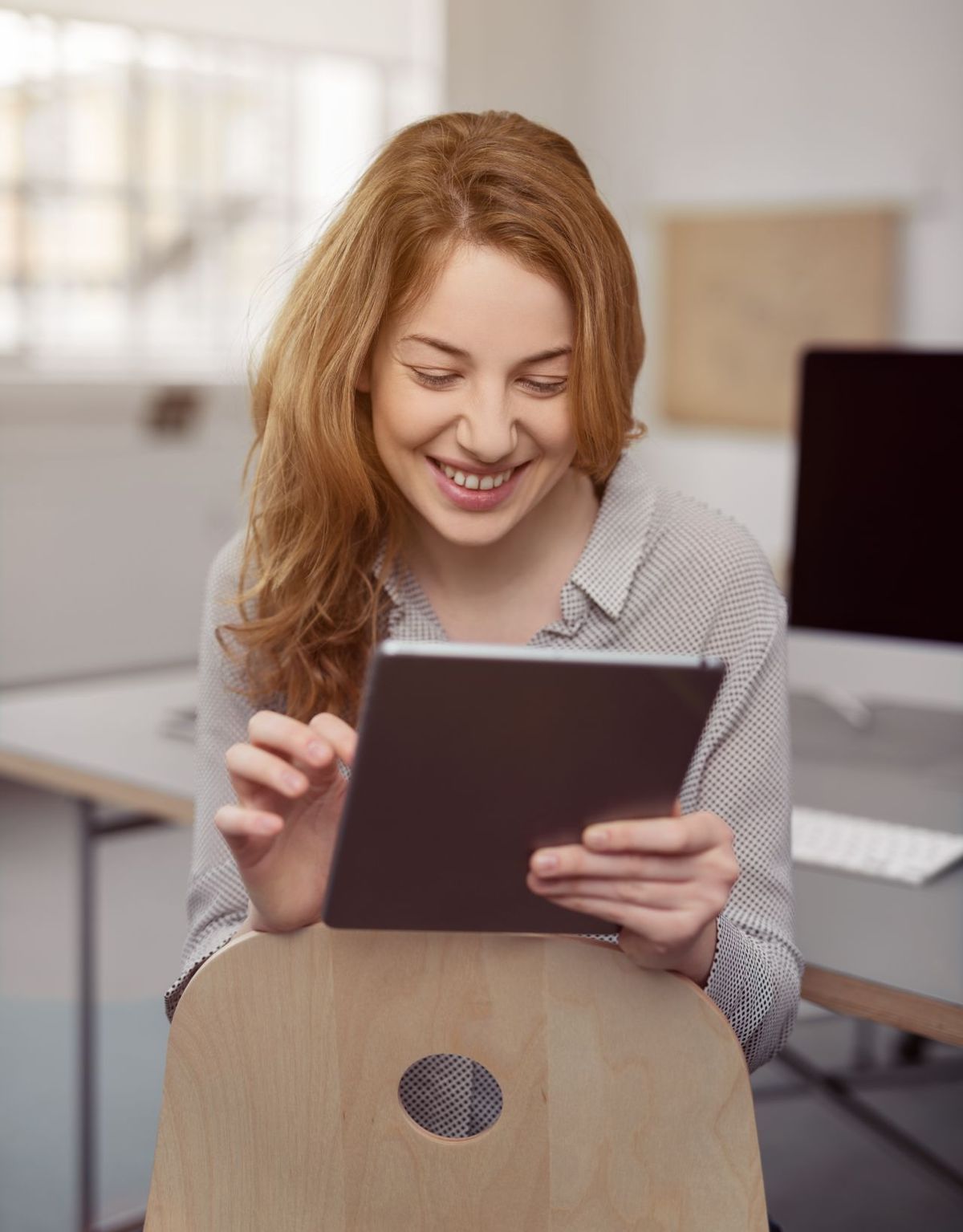 Woman saving content on a tablet